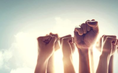 Peoples raised fist air fighting and sunlight effect, Competition, teamwork concept.