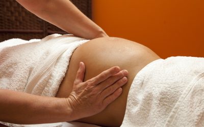 Young pregnant woman receiving relaxing massage