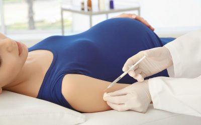 Young pregnant woman receiving vaccination in clinic
