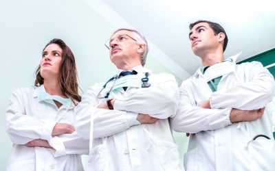 Young and senior doctors ready to fight against coronavirus outbreak at hospital clinic - Medical emergency concept about worldwide virus contagion spread - Bright neutral filter